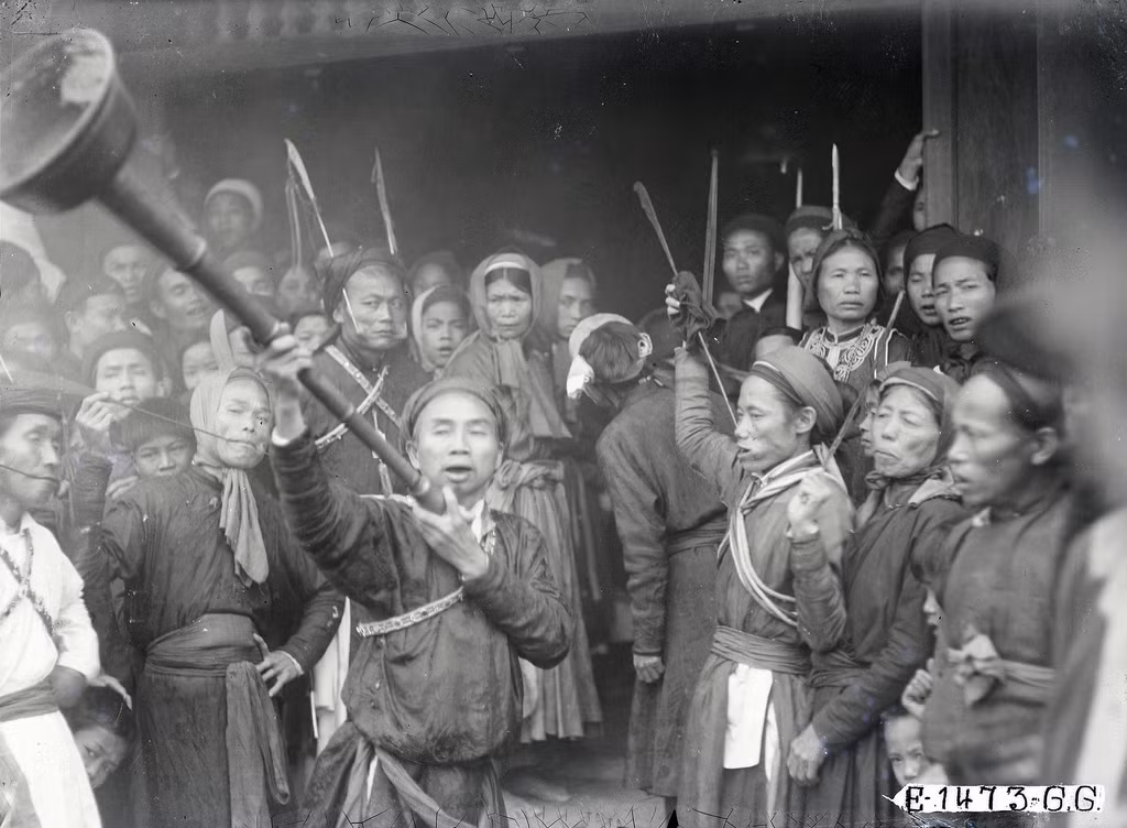 Một người dùng loa kêu gọi đám đông nhường lối cho đám rước đi qua.