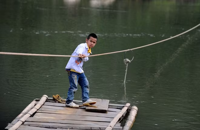 Những đứa trẻ ở xã nghèo này đã quá quen với đi mảng, đôi khi chúng còn tự kéo dây vượt suối.