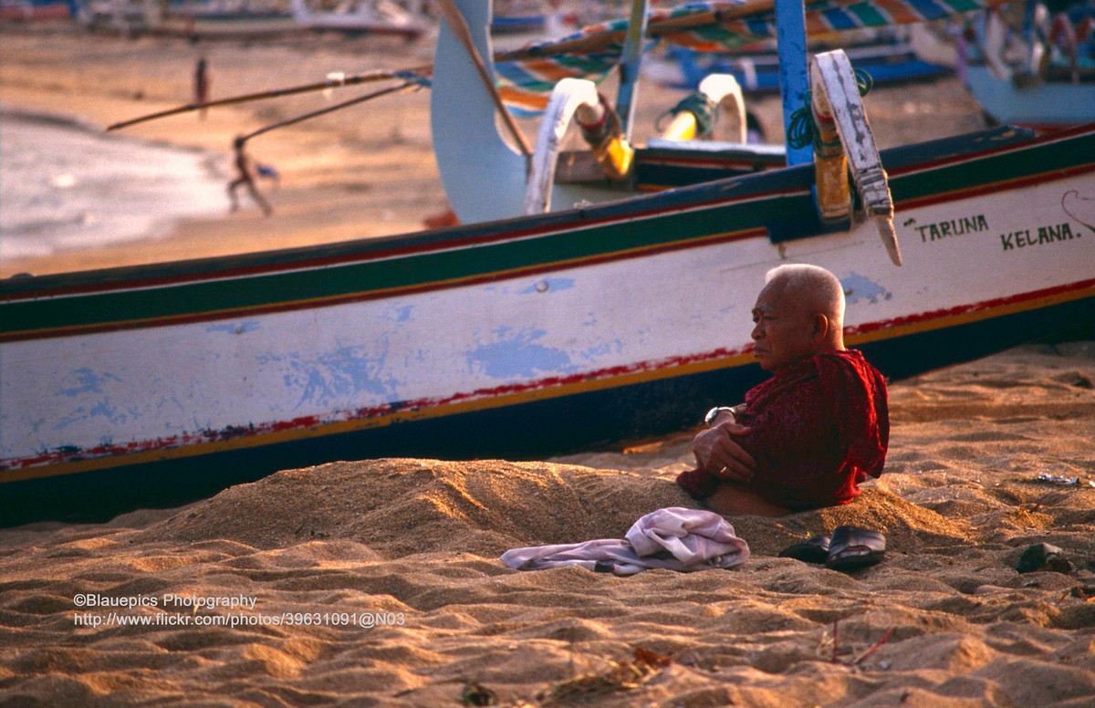 Cụ ông vùi mình trong cát.