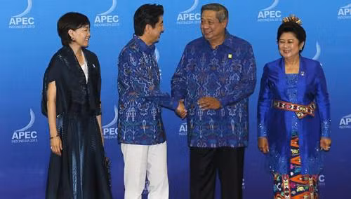 Thủ tướng Nhật Bản Shinzo Abe (trái) bắt tay thân mật với Tổng thống Indonesia Susilo Bambang Yudhoyono (phải). Bên cạnh ông Abe là phu nhân của ông, bà Akie và bên cạnh ông Yudhoyono là phu nhân Ani Yudhoyono.