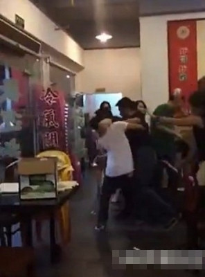 Nam thanh niên áo đen và nhóm "nữ quái" bị các nhân viên đẩy ra ngoài cửa nhà hàng.