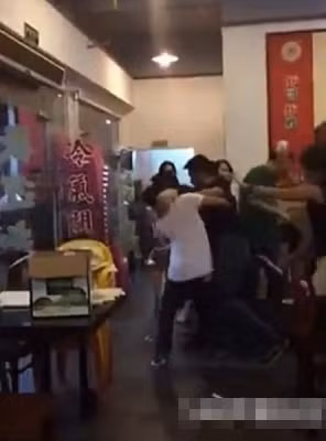 Nam thanh niên áo đen và nhóm "nữ quái" bị các nhân viên đẩy ra ngoài cửa nhà hàng.