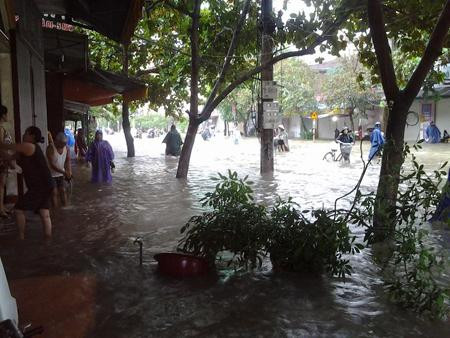 Xe máy không thể hoạt động, người dân buộc phải xắn quần lội bộ. Ảnh: Nông nghiệp VN.