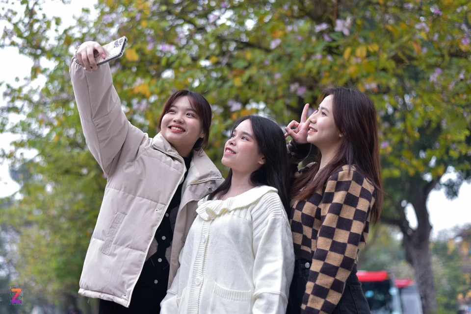 Ngọc Diệp, Thanh Thương và Huyền Trang (quận Hai Bà Trưng) cho biết đây là lần đầu cả ba chủ động đi chụp ảnh hoa ban. “Những bức ảnh check-in với hoa ban đang rộ lên trên mạng xã hội. Chúng mình giục nhau phải nhanh chóng đi ngắm trước khi hoa tàn", Ngọc Diệp (bên trái) nói với Tri thức - Znews.