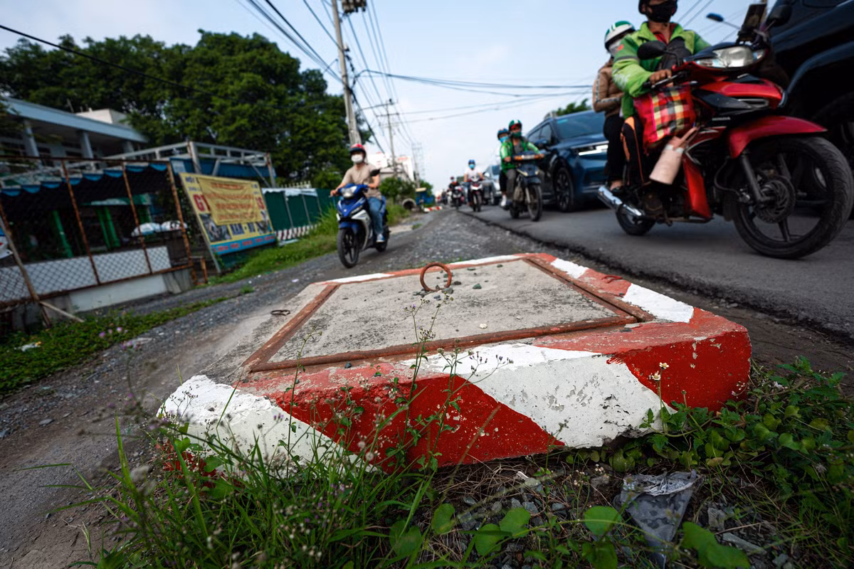 Miệng cống thoát nước trồi lên giữa đường, gây nguy hiểm cho người tham gia giao thông. 