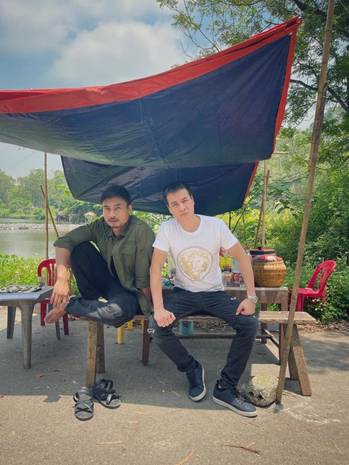 Duy Hưng và Anh Đức ngồi thở ở bối cảnh phim 'Mùa hoa tìm lại' ở ngoại thành Hà Nội trong những ngày nắng nóng.