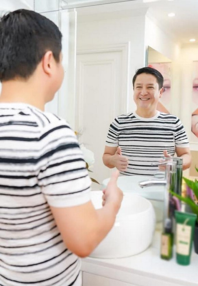 Chí Trung tự ngắm mình trong gương.