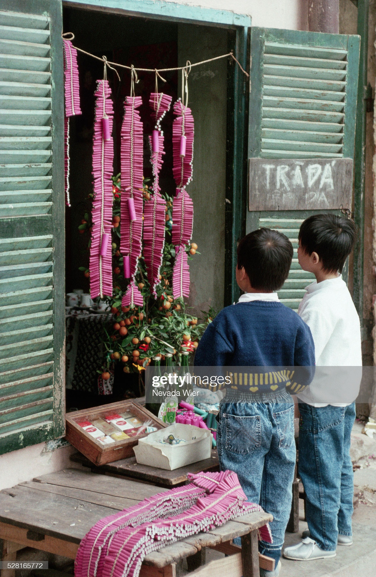 Nevada Wier ghi lại hình ảnh thú vị khi hai cậu bé đang chăm chú nhìn những tép pháo. Tiếng nổ của pháo từng là âm thanh quen thuộc trong những ngày Tết xưa. Tuy nhiên, vì vấn đề an toàn, đa số các loại pháo hiện nay đều đã bị cấm trên thị trường. Ảnh: Nevada Wier.