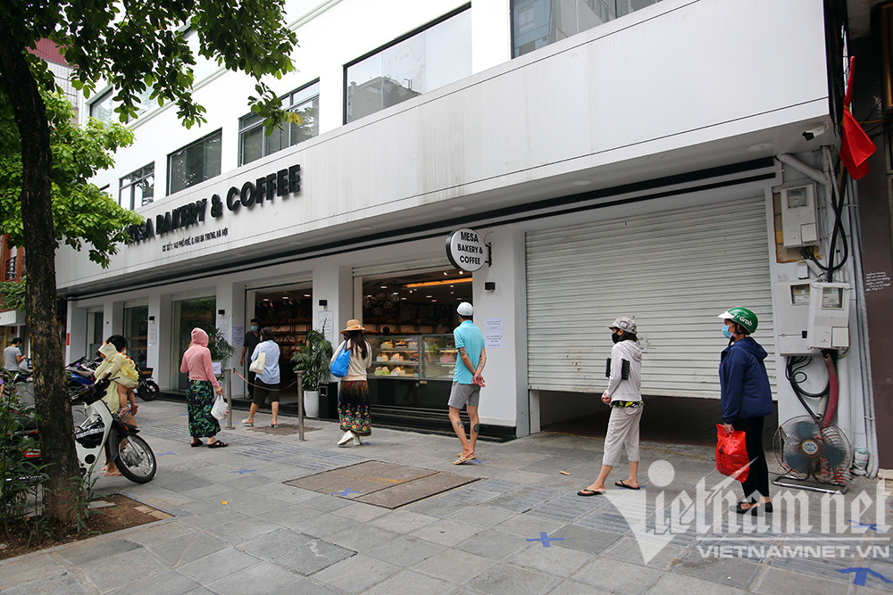 Quán bán bánh mỳ trên phố Huế vẫn còn duy trì hoạt động, nhưng người đến mua hàng đã theo nhịp sống giãn cách, đứng cách nhau cả mét chờ tới lượt mua bánh bánh mỳ.