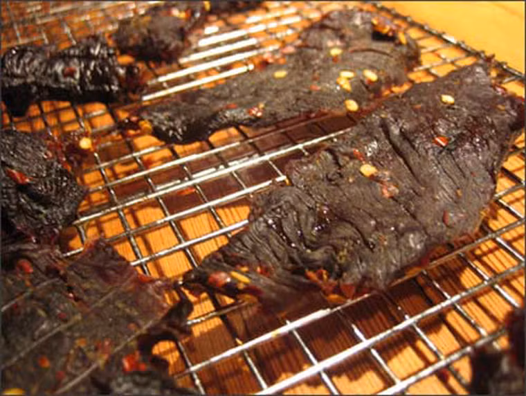 Khi thưởng thức, người dân nơi đây đem thịt nướng sơ qua trên than củi hoặc vùi trong tro bếp cho thịt nóng, xé tơi ra thành từng miếng nhỏ, chấm với muối tiêu rừng trộn lá é. Lá é là loại gia vị thường mọc ven bờ suối, quanh con nước. Lá có vị hăng hắc hòa quyện với vị mặn của muối khiến miếng thịt trở nên thơm ngon trọn vẹn.