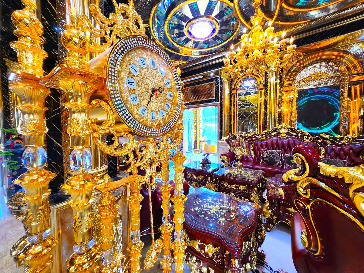 Chiếc đồng hồ cùng bộ đèn trần màu vàng tô điểm cho không gian thêm sang trọng.