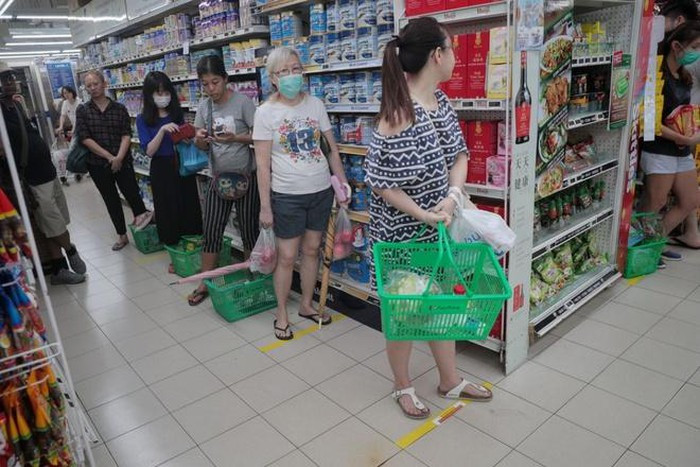 Ở Singapore, người đi siêu thị không đứng cách xa nhau đủ 2 m. Ảnh: The Straits Times.