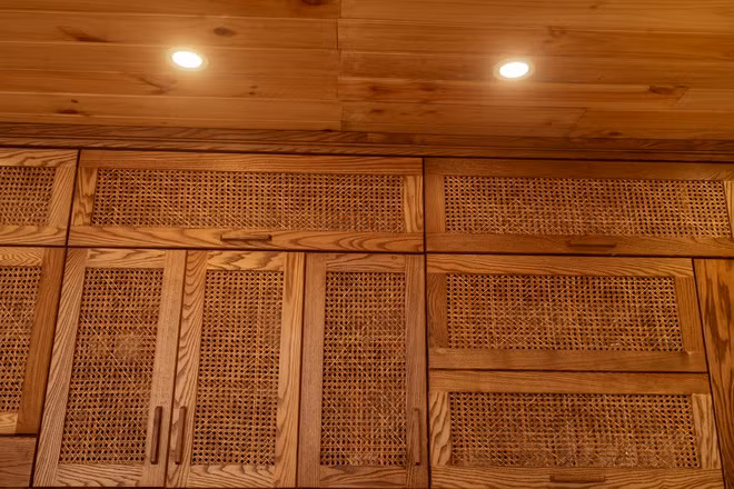 Phần nổi bật của căn bếp cũng là điều mà Anh Thư tự hào nhất là tủ bếp thiết kế theo kiểu chạn bếp xưa. Thay vì bộ tủ theo phom hiện đại như bản vẽ nhà ban đầu, vợ chồng Duy - Thư thuê thợ mộc đóng riêng tủ bếp chữ L dài 5 m với chất liệu gỗ sồi Mỹ. Để tạo ra sự khác biệt, Thư nghĩ ra ý tưởng phá cách phần cánh tủ.