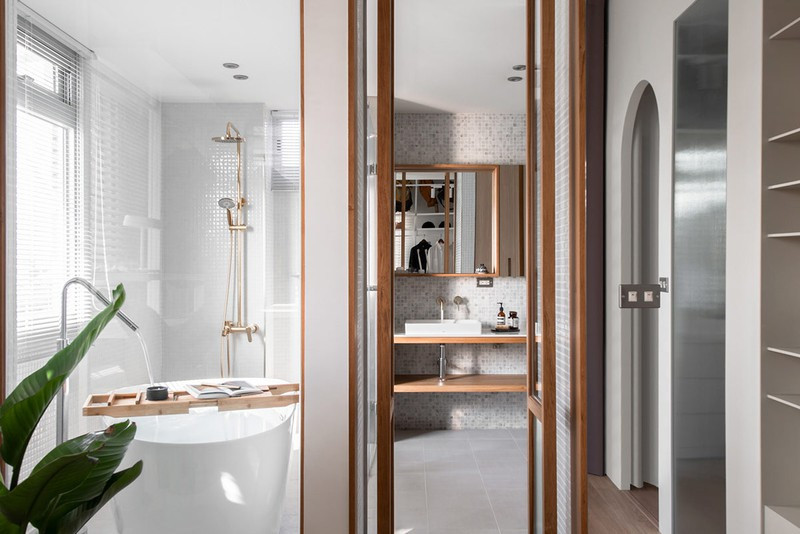 Cửa đôi khung gỗ kết nối khu vực thay đồ với phòng tắm riêng.