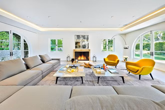 Phòng khách sáng sủa, thoáng đãng với những ô cửa kính xung quanh đem lại ánh sáng tự nhiên và cảnh sắc sân vườn xanh mướt.