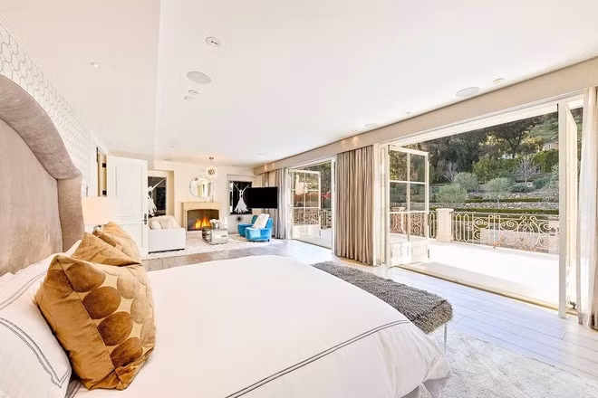 Phòng ngủ chính rộng rãi mang tông màu be trang nhã, được trang bị một khu vực tiếp khách. Những cánh cửa kiểu Pháp mở ra ban công thoáng mát.