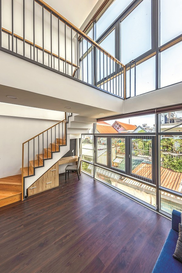 Sàn tầng 2 trước nhà là nơi học và giải trí của trẻ con. Từ đây lên tầng 3 cầu thang được đẩy về phía trước nhà. Khoảng thông tầng khác từ tầng 2 lên tầng 3 tạo cảm giác hành lang phía trên như một chiếc cầu bắc giữa không gian.