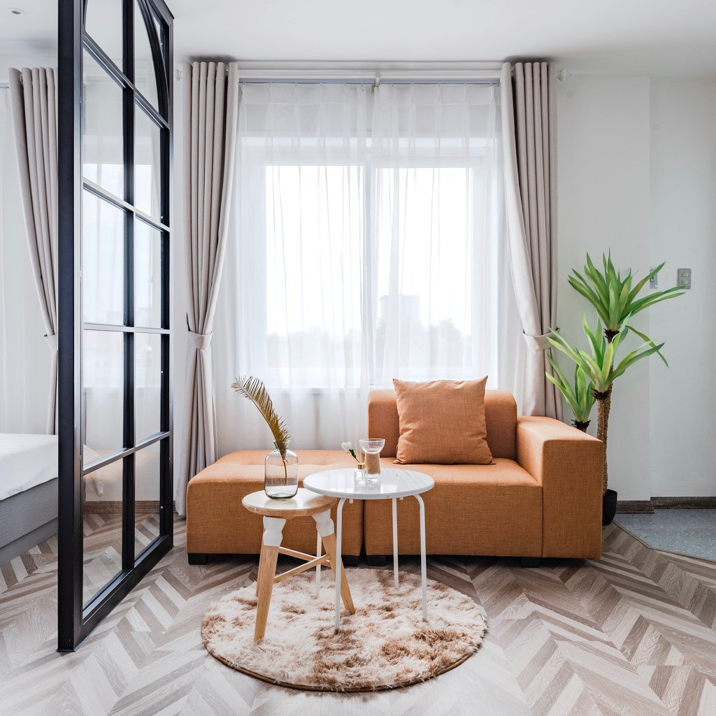 Không gian tiếp khách được bố trí bộ sofa nhỏ gọn, đơn giản với gam màu ấm làm điển nhấn.