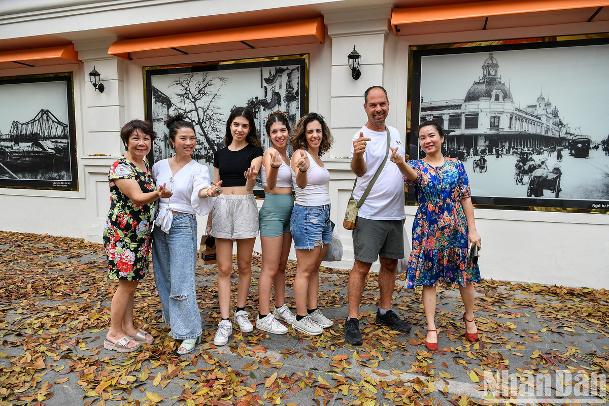 Du khách nước ngoài thích thú chụp ảnh trên góc phố tuyệt đẹp, giữa lá vàng và những bức ảnh nghệ thuật.