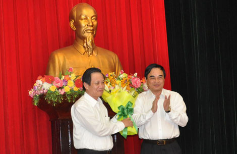 Ông Trần Thọ (trái) nhận hoa chức mừng của ông Văn Hữu Chiến, chủ tịch UBND TP Đà Nẵng.