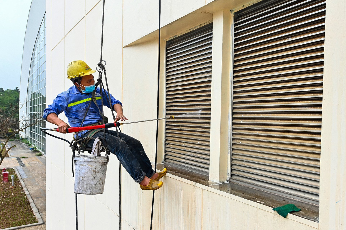Phía bên trong bể bơi vẫn ngổn ngang với vật liệu xây dựng, trang biết bị chưa được lắp đặt xong. Công nhân gấp rút thi công, vệ sinh cả phía bên ngoài lẫn bên trong để kịp hoàn thành tiến độ đã đề ra.