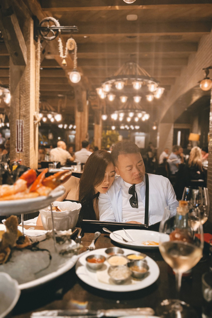 Phương Oanh ngả vào Shark Bình khi cả hai xem thực đơn trong một nhà hàng sang trọng tại Mỹ.