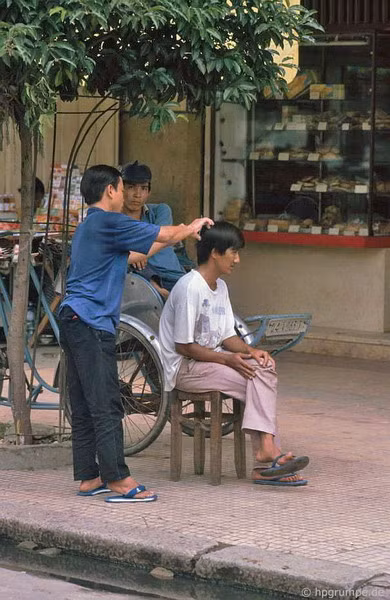 Chỉ cần một cái ghế gỗ đặt trên vỉa hè là đủ để hành nghề.