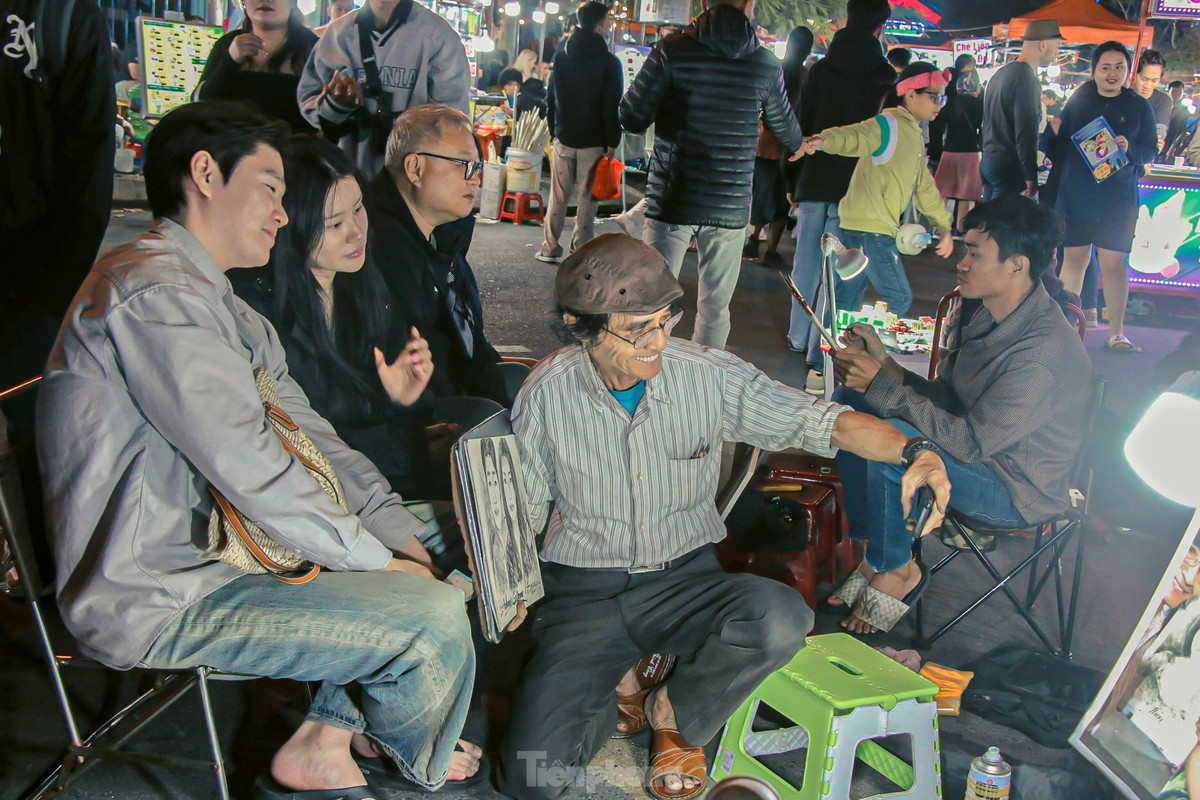 Ký họa chân dung đường phố tại chợ đêm Sơn Trà hút khách. Nhiều cặp đôi cũng tranh thủ cùng nhau lưu giữ kỉ niệm bằng những bức tranh vẽ chính mình tại chợ.