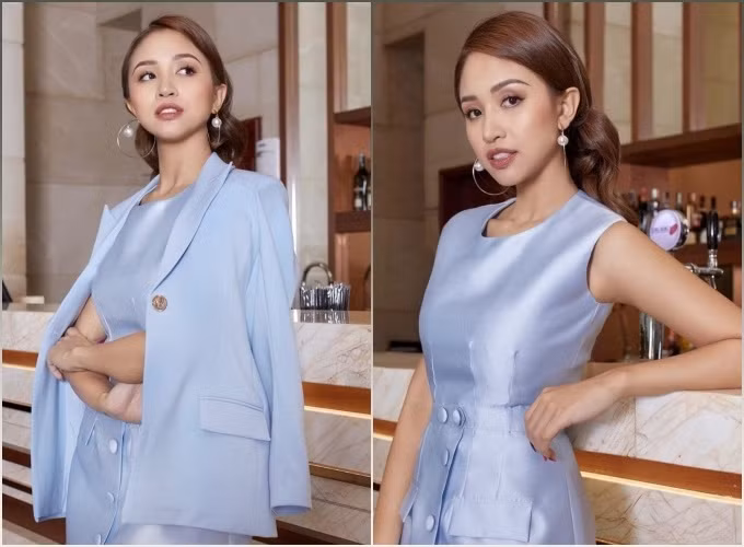 Vân Hugo tạo dáng sang chảnh khi diện váy tafta màu xanh bóng với hàng cúc bọc chạy dọc thân váy, khoác cùng áo blazer đồng màu. Nữ MC chọn lối trang điểm nâu trầm, mix cùng khuyên tai tròn bản to.