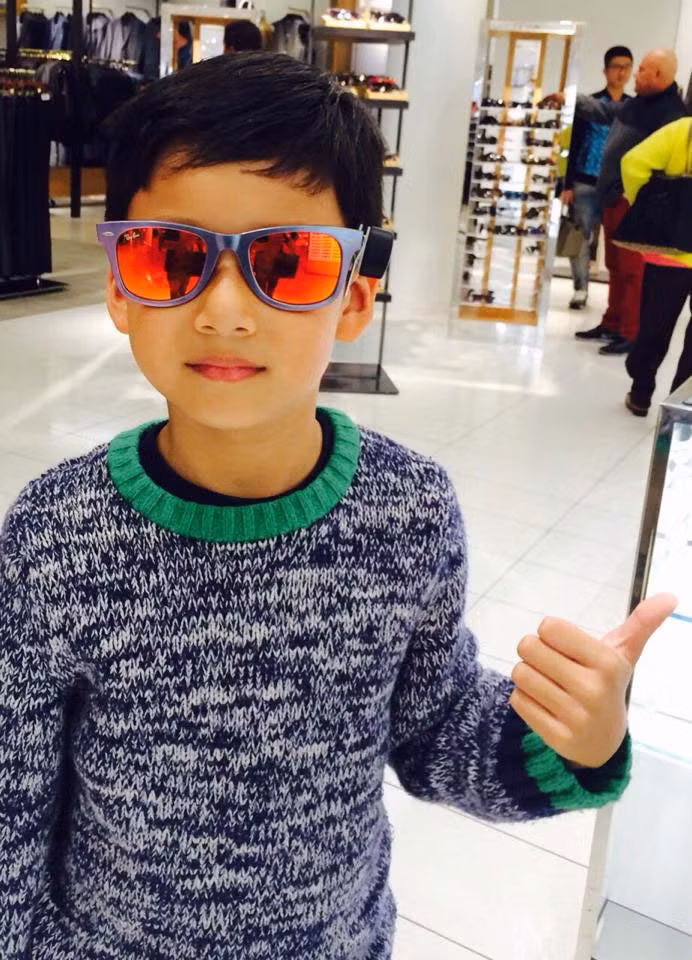 Bảo Nam đeo thử kính trong một gian hàng.