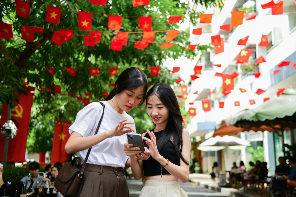 Biết đến địa điểm này qua TikTok, Hằng và Luyện (TP Thủ Đức) chọn đây là điểm dừng chân cho ngày đầu nghỉ lễ. Cả 2 cho biết ở TP.HCM không quá nhiều chỗ vui chơi , vì vậy đi uống cà ngắm cờ hoa là trải nghiệm khá thú vị trong kỳ dịp nghỉ lễ. "Khu vực này thoáng mát, ít xe cộ qua lại nên không khí trong lành, dễ chịu, chụp ảnh lên khá xinh mà không ảnh phiền đến mọi người qua lại", Hằng chia sẻ.