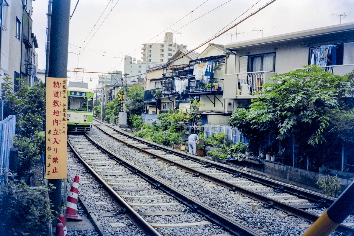 Một người đàn ông làm vườn bên tuyến đường sắt gần ga Ikebukuro.