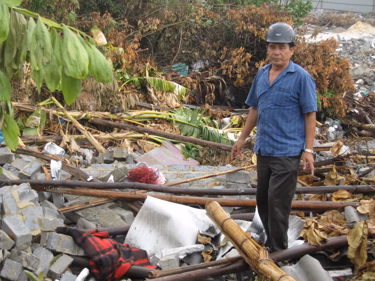 Ông Nguyễn Văn Hỵ bên đống đổ nát từng là nhà ở sau khi cưỡng chế.