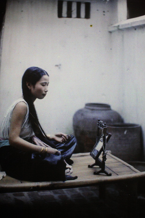 Thiếu nữ ngồi trước gương.