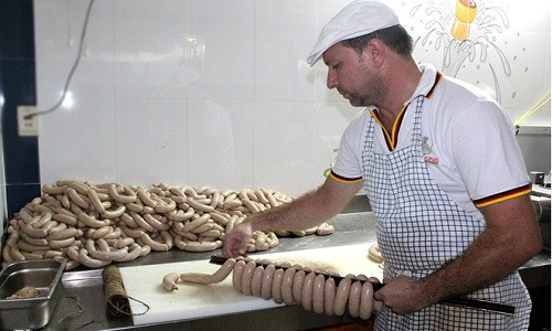 Ông Klaus Rutt cẩn thận xếp từng dây xúc xích để cho vào lò xông khói. Chúng phải trải qua nhiều chế độ khác nhau trong lò. Sức chứa của một lò ở đây hơn 1.000 cây, và phải mất 2h 30 phút để ra một mẻ xúc xích mới.