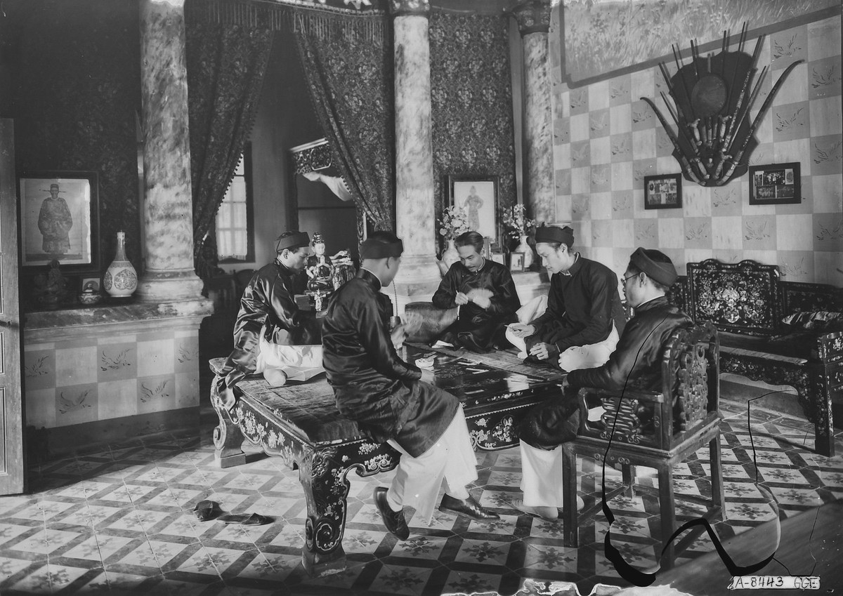 Các quý ông chơi tổ tôm trong một dinh thự được trang hoàng lộng lẫy.