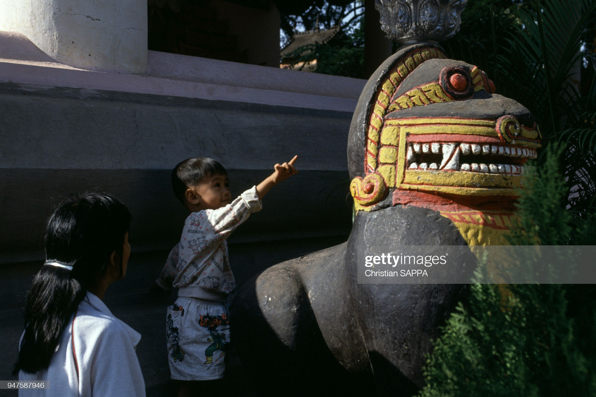 Cậu bé bên bức tượng ở chùa Wat Inpeng.