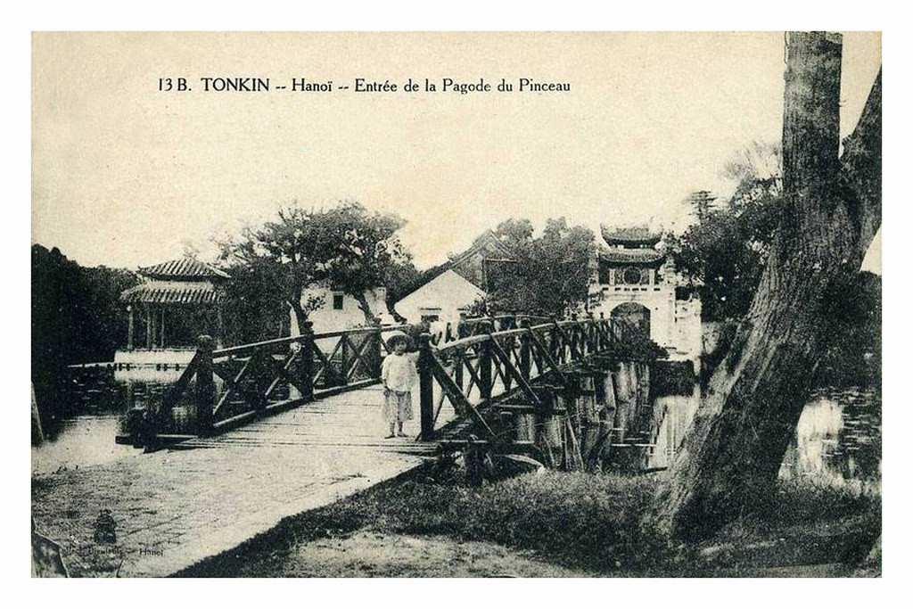 Em bé đứng ở đầu cầu Thê Húc.