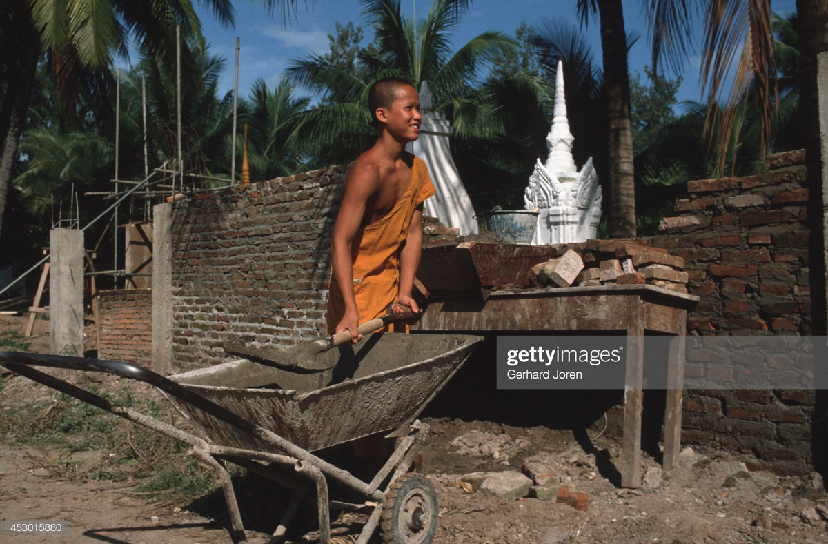 Nhà sư trẻ tham gia xây dựng tại một ngôi chùa ở Vientiane.