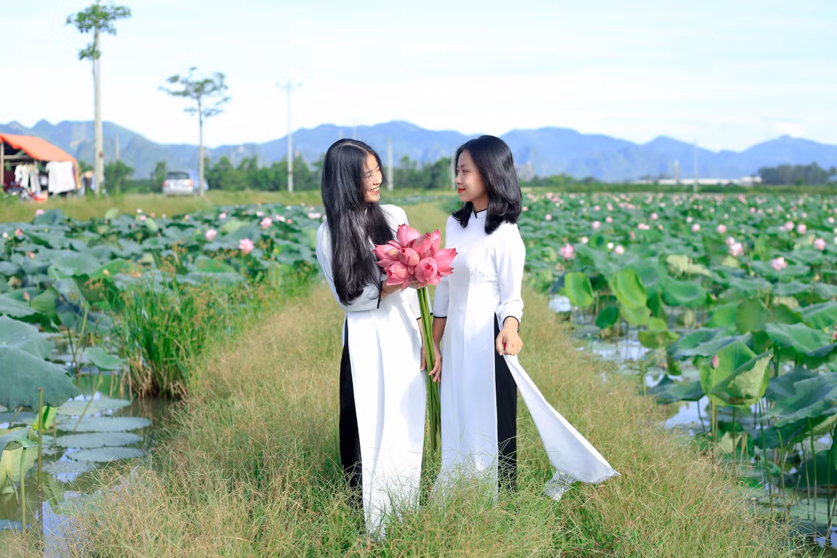 Phạm Thị Trà My (bên phải) cho biết đây là lần thứ 3 mà cô chụp ảnh ở đầm sen. "Tôi đã đi chụp sen ở một số địa điểm khác rồi nhưng thấy nơi này vẫn là đẹp nhất. Ở đây không chỉ có sen mà còn có không gian được bao quanh bởi các dãy núi tạo nên một khung cảnh kì vỹ", Trà My nói.