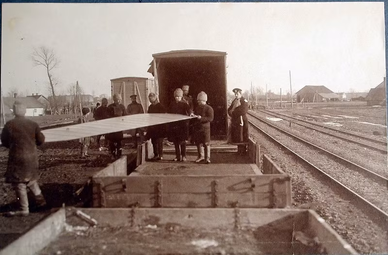 Những người lính cẩn thận di chuyển các bộ phận của máy bay từ toa tàu hỏa.