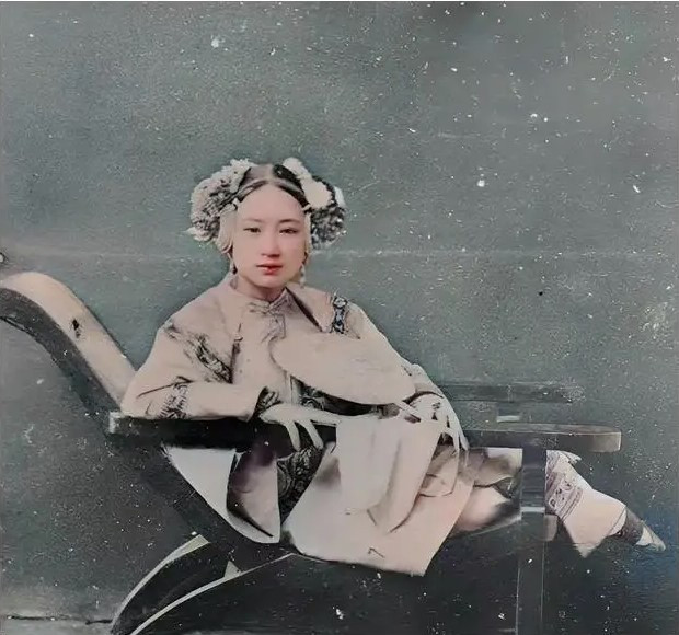  Khuôn mặt của người phụ nữ này trông rất phóng khoáng. Cô có một dáng người nhỏ nhắn và thanh tú. Đánh giá từ trang sức cài trên đầu và chiếc quạt trên tay, cô gái này hẳn là một tiểu thư chưa chồng, xuất thân từ một gia đình giàu có.