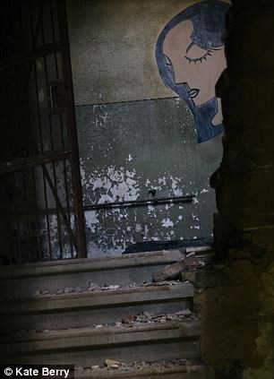 Lối cầu thang đầy rác, gạch vụn và những mảng tường loang lổ.