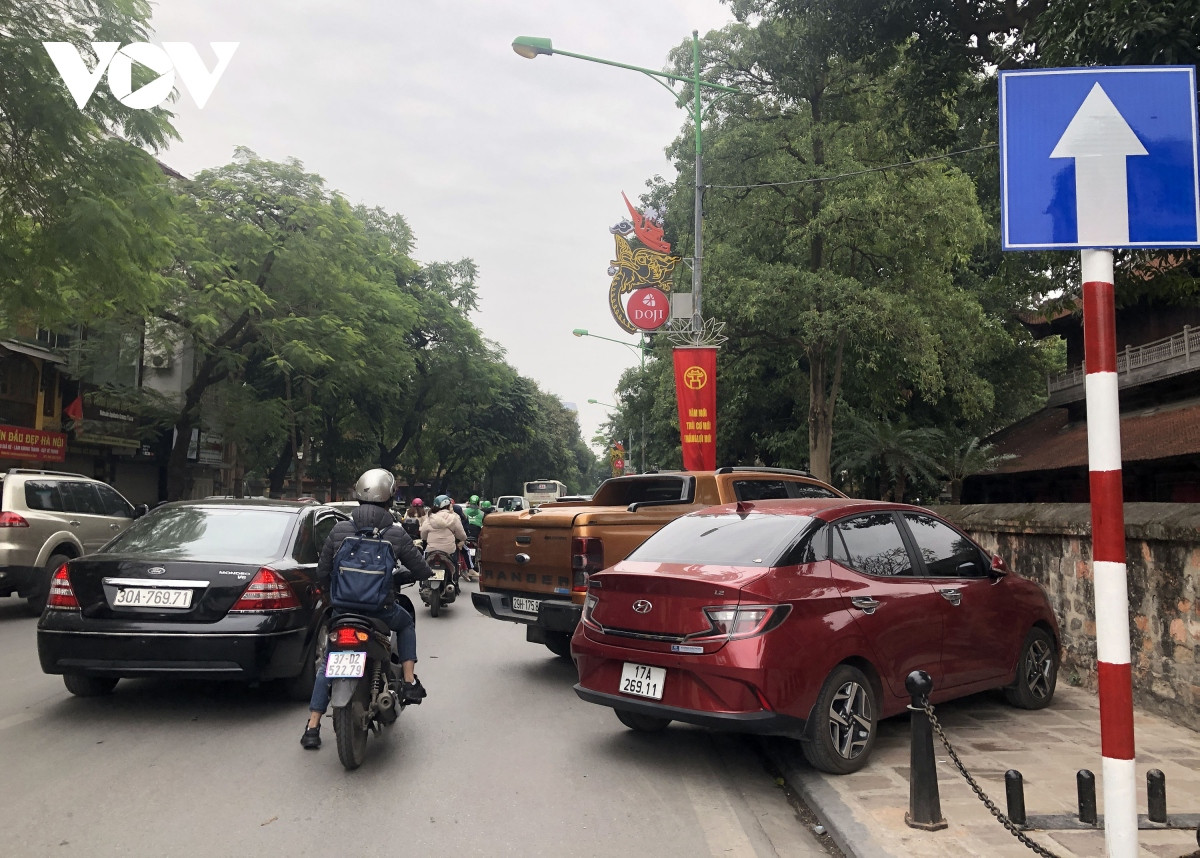 Xe đỗ "thò đuôi" dưới lòng đường Nguyễn Thái Học phía sau Văn Miếu nơi có mật độ phương tiện đi lại đông.