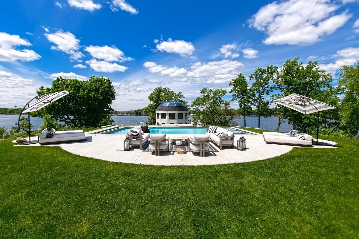 Những tiện nghi bên ngoài biệt thự bao gồm 1 bể bơi, 1 quầy bar ngoài trời và một số khu vực tiếp khách.