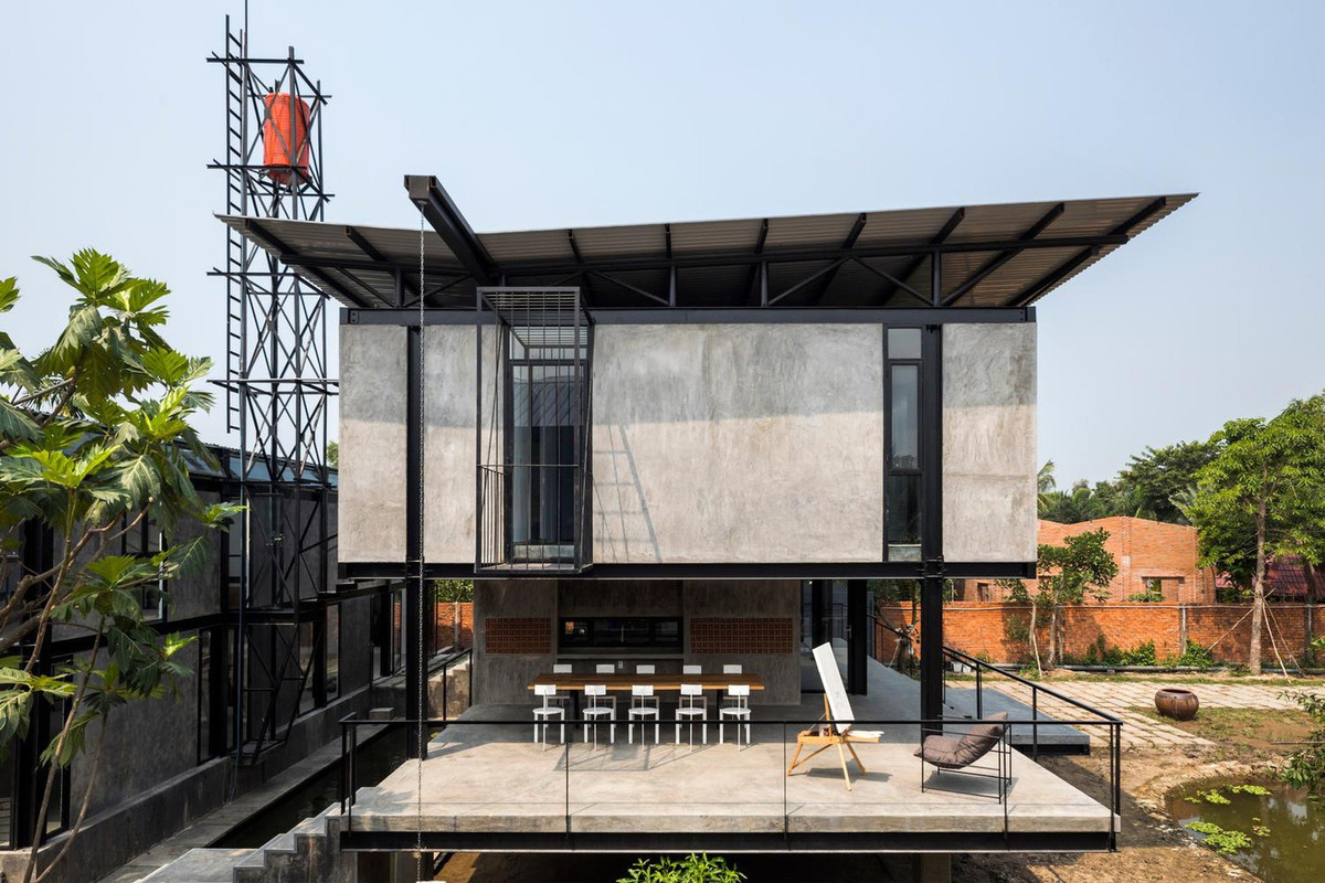 Kiến trúc sư Truong An Architecture thiết kế ngôi nhà sàn 300 m² hiện đại, bao gồm hai khối nhà hình chữ nhật với hai ao tự nhiên nối trực tiếp với kênh.