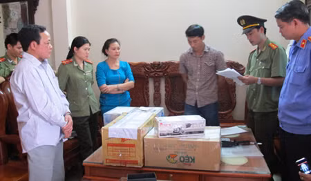 "Cậu Thủy" (trái) lúc cơ quan công an đọc lệnh bắt.