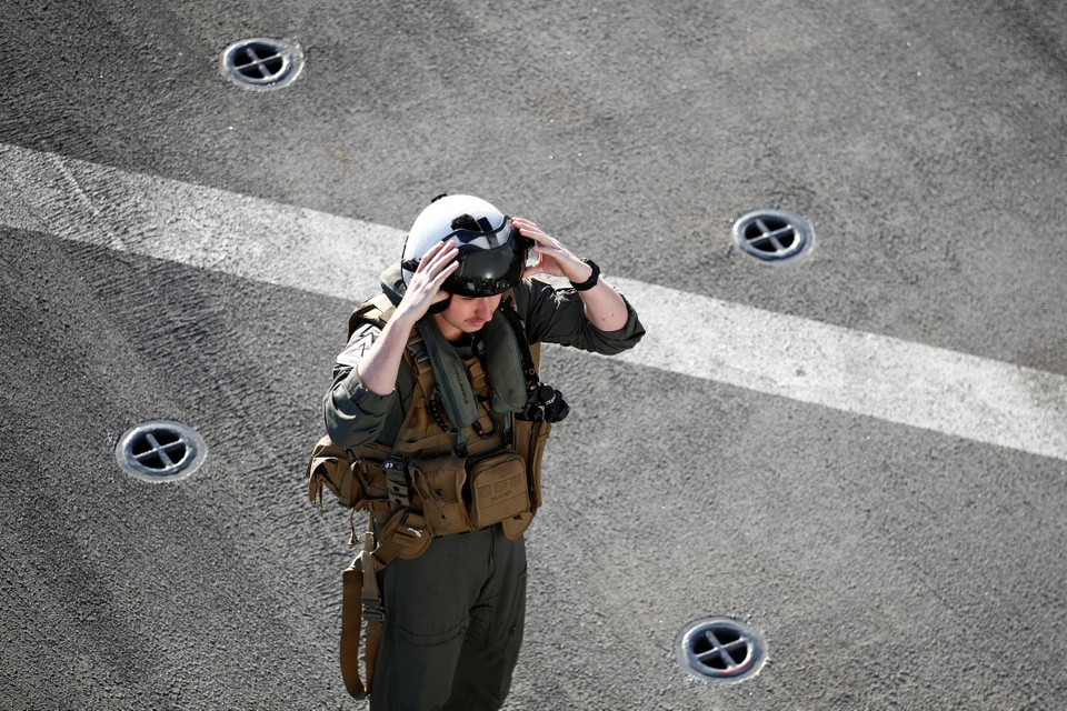 br/> Một phi công của USS Portland kiểm tra thiết bị trước khi cất cánh trên một chiếc trực thăng MH-60.