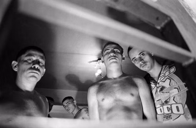 Các tù nhân đứng trong phòng biệt giam. Họ chỉ có thể nhìn thấy ánh sáng mặt trời qua một ô cửa sổ trên cao. Ảnh: Alex Majoli.