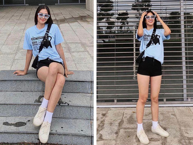 ##s###Lần khác,Tiểu Vy xuất hiện trong trang phục áo phông xanh mặc cùng quần short đen. Cô nàng khéo léo chọn phụ kiện kính râm cùng màu áo và đeo thêm túi chéo